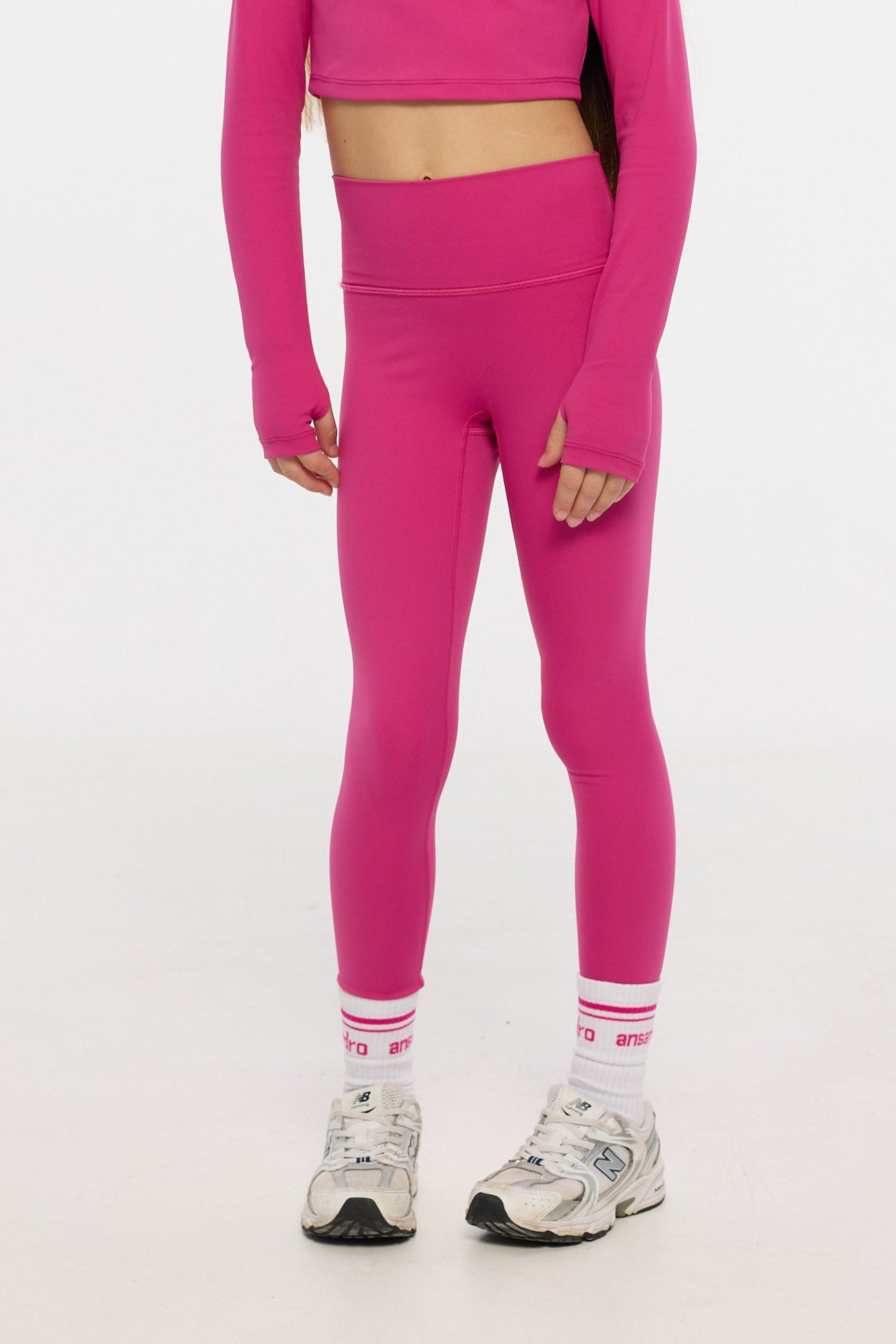 Person wearing a pink outfit on a white background