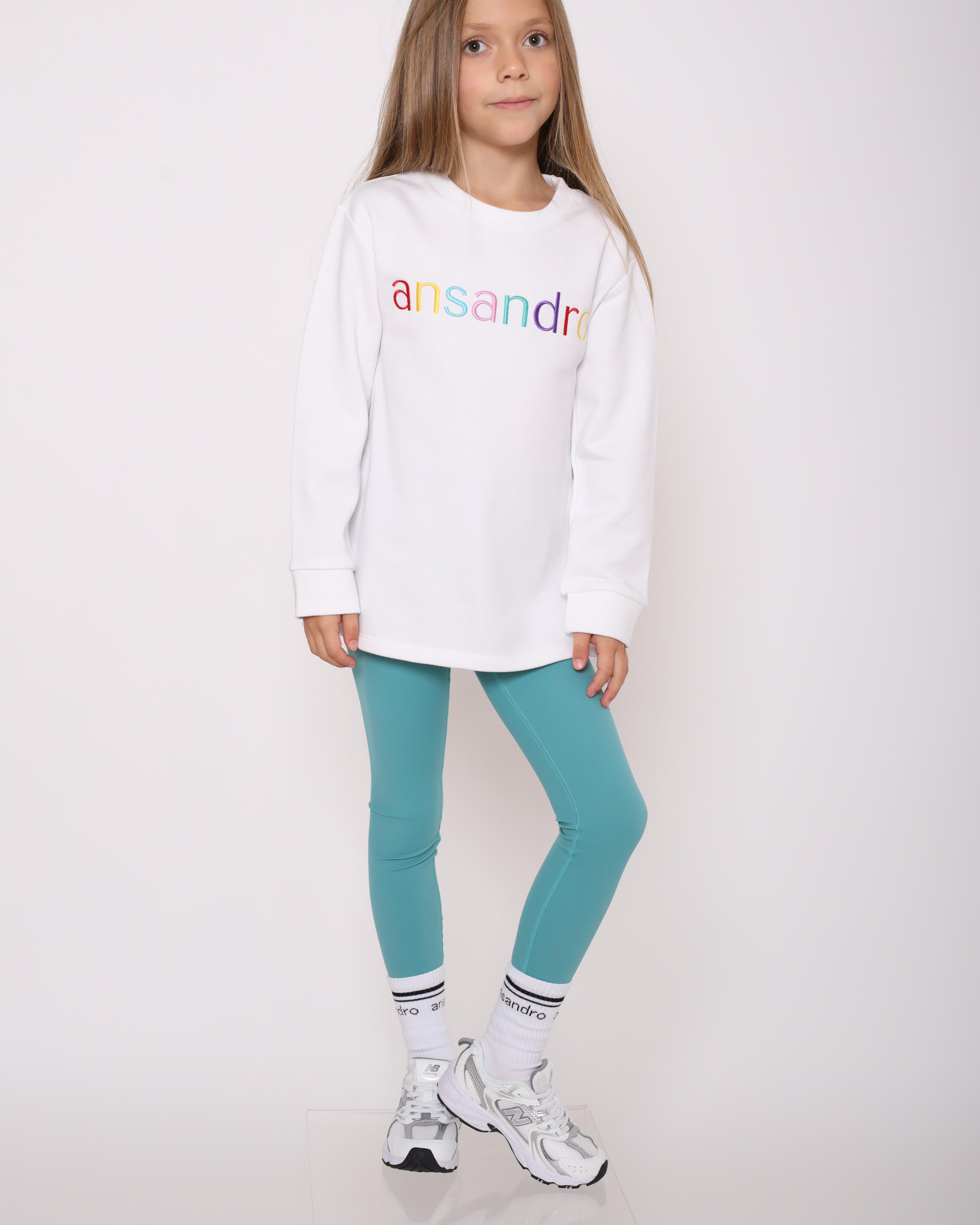 White lightweight sweatshirt for kids - 100% cotton with colourful embroidered branding paired with teal high-waisted leggings and branded socks