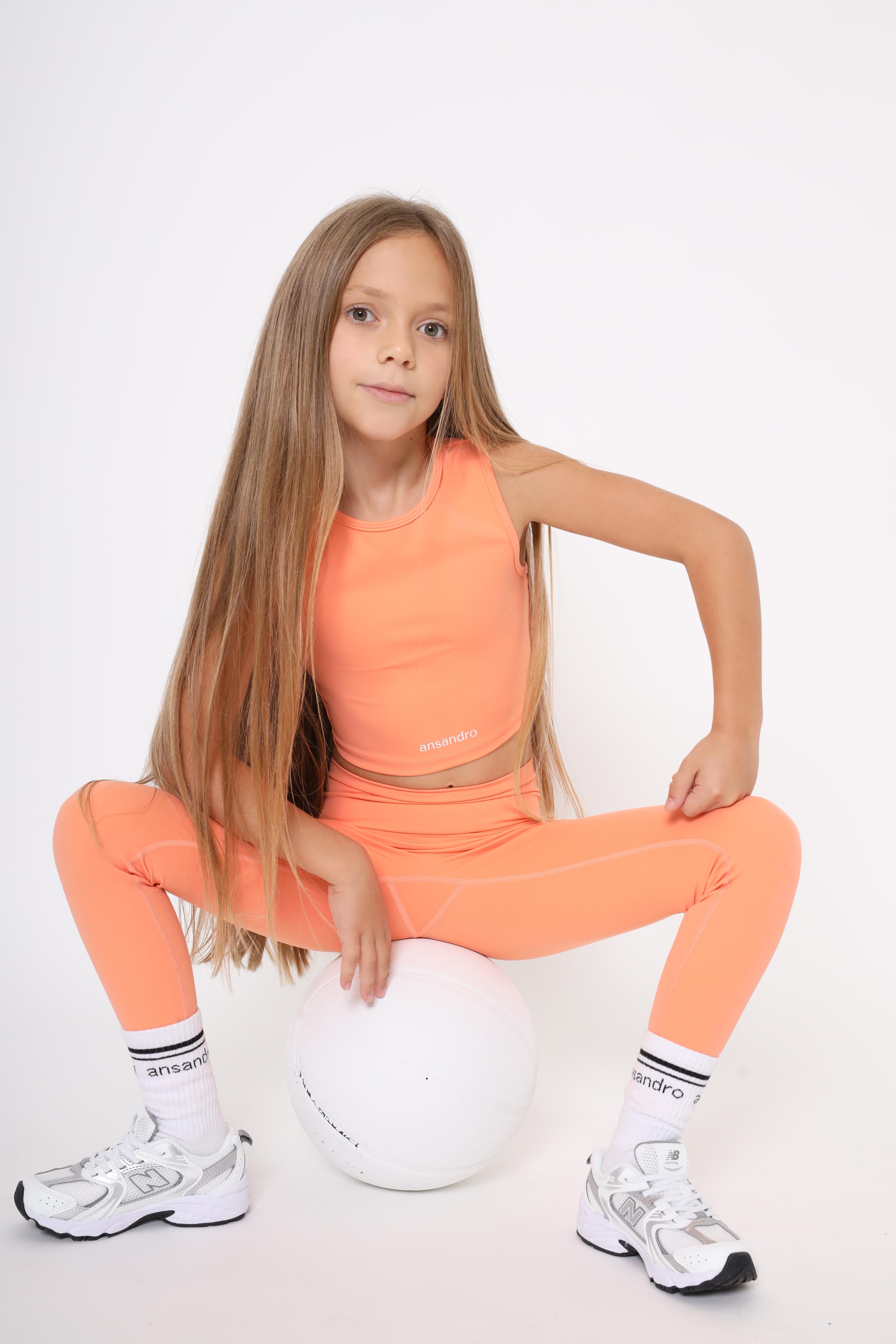 High-waisted leggings for active kids aged 5-14 - comfortable and versatile - orange with branded socks and matching cropped tank top
