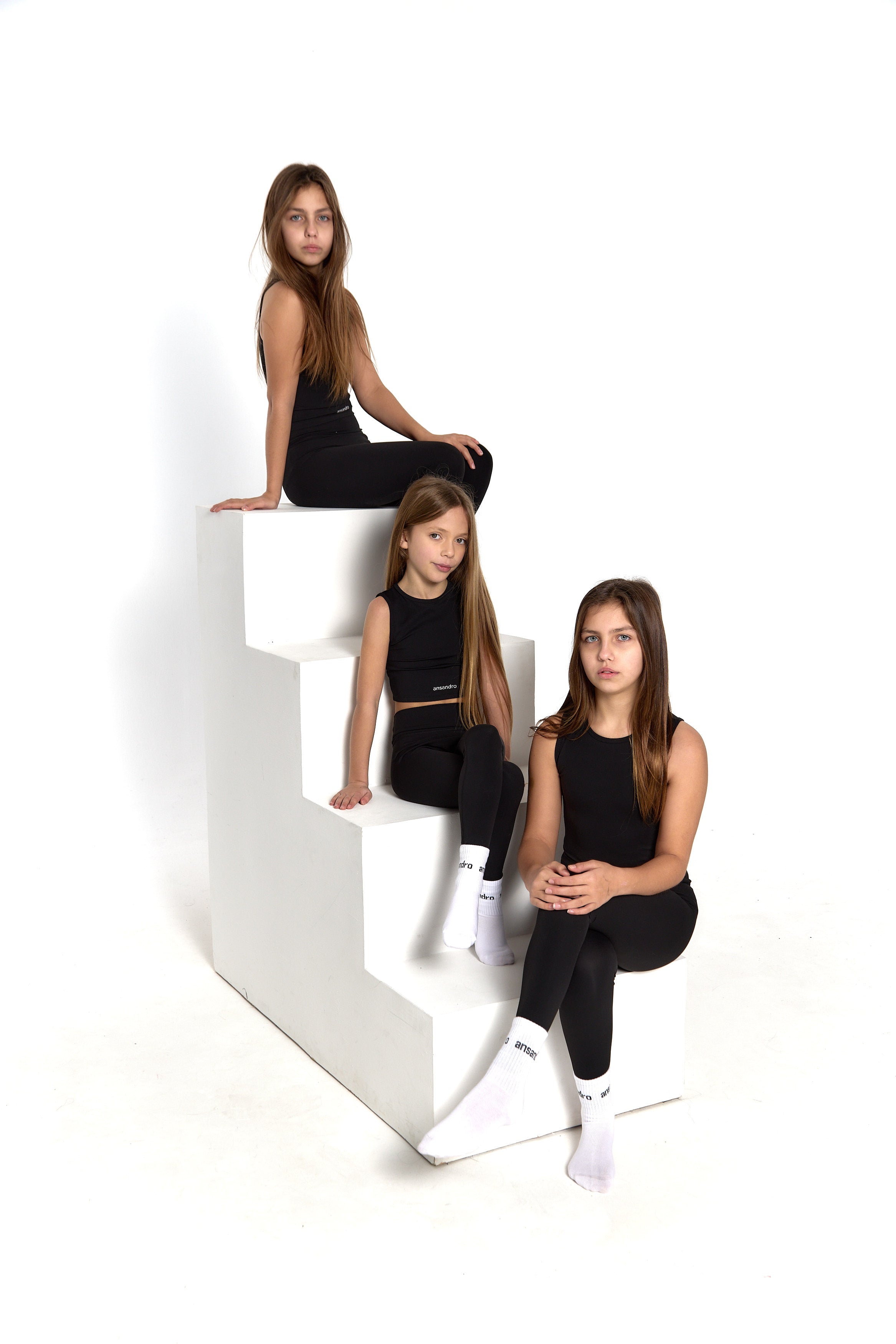 Ansandro girls' cropped tank in black - premium kids' activewear with matching black high-waisted leggings and branded socks