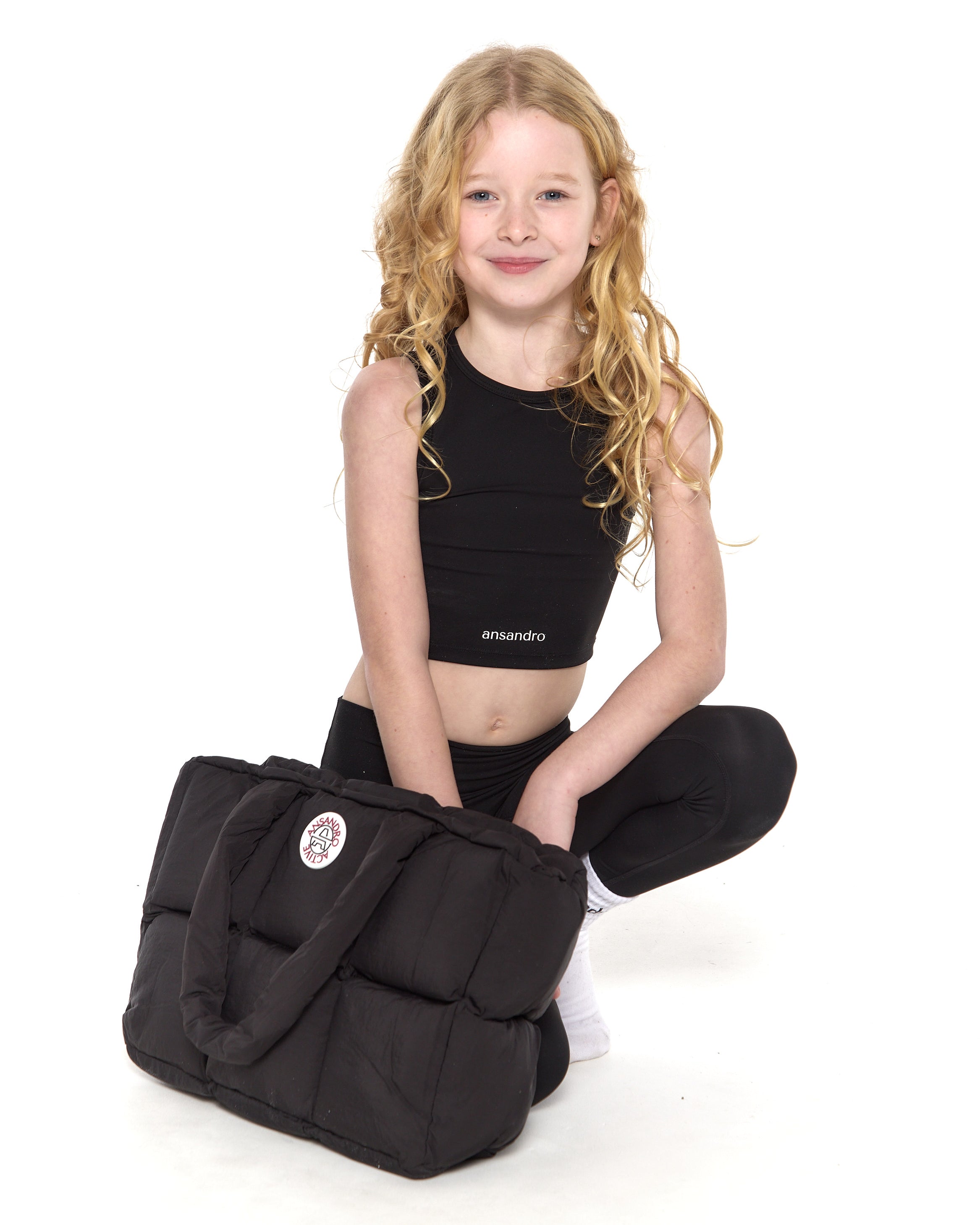 Premium black puffer bag with branding - perfect for active kids