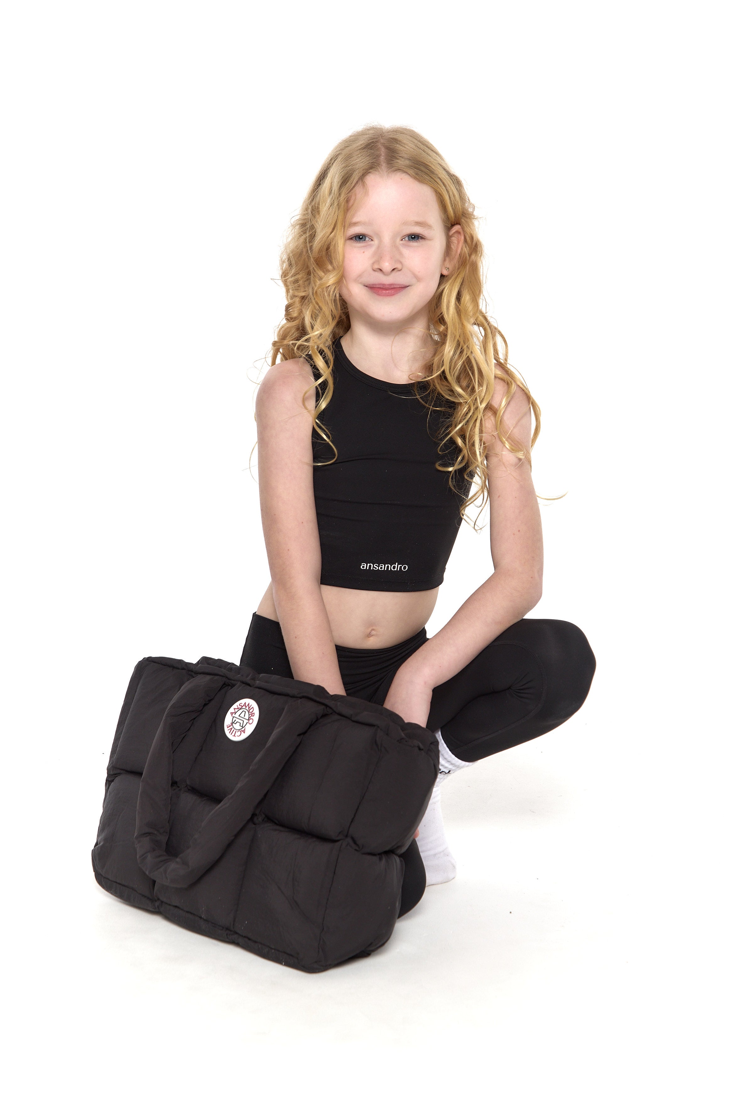 Premium black puffer bag with branding - perfect for active kids