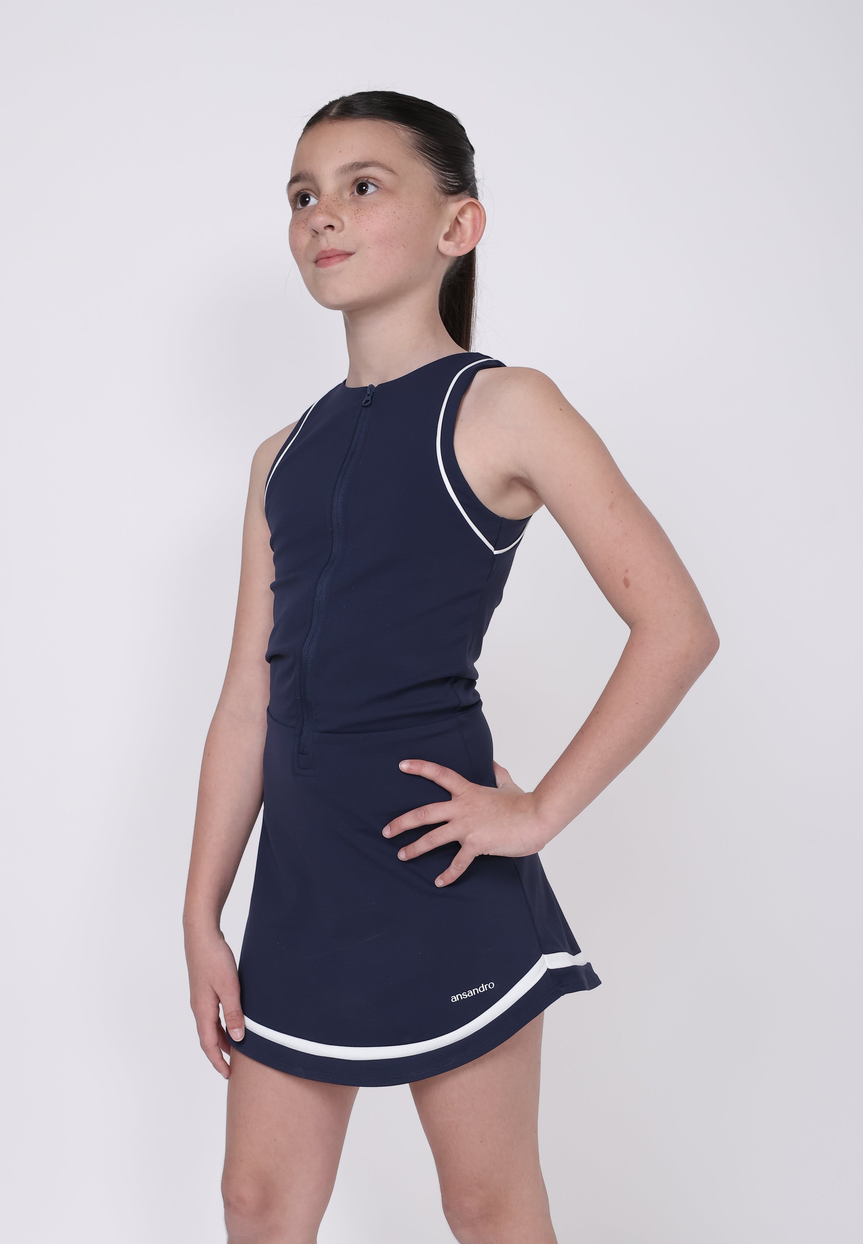 Person lying on a white surface wearing a navy blue athletic outfit with white accents.