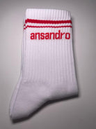 100% cotton branded socks for kids - soft, breathable, and durable design. Red text and red banding