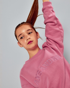 Girl wearing the Ansandro Kids blush 100% cotton sweatshirt with tonal embroidered logo.