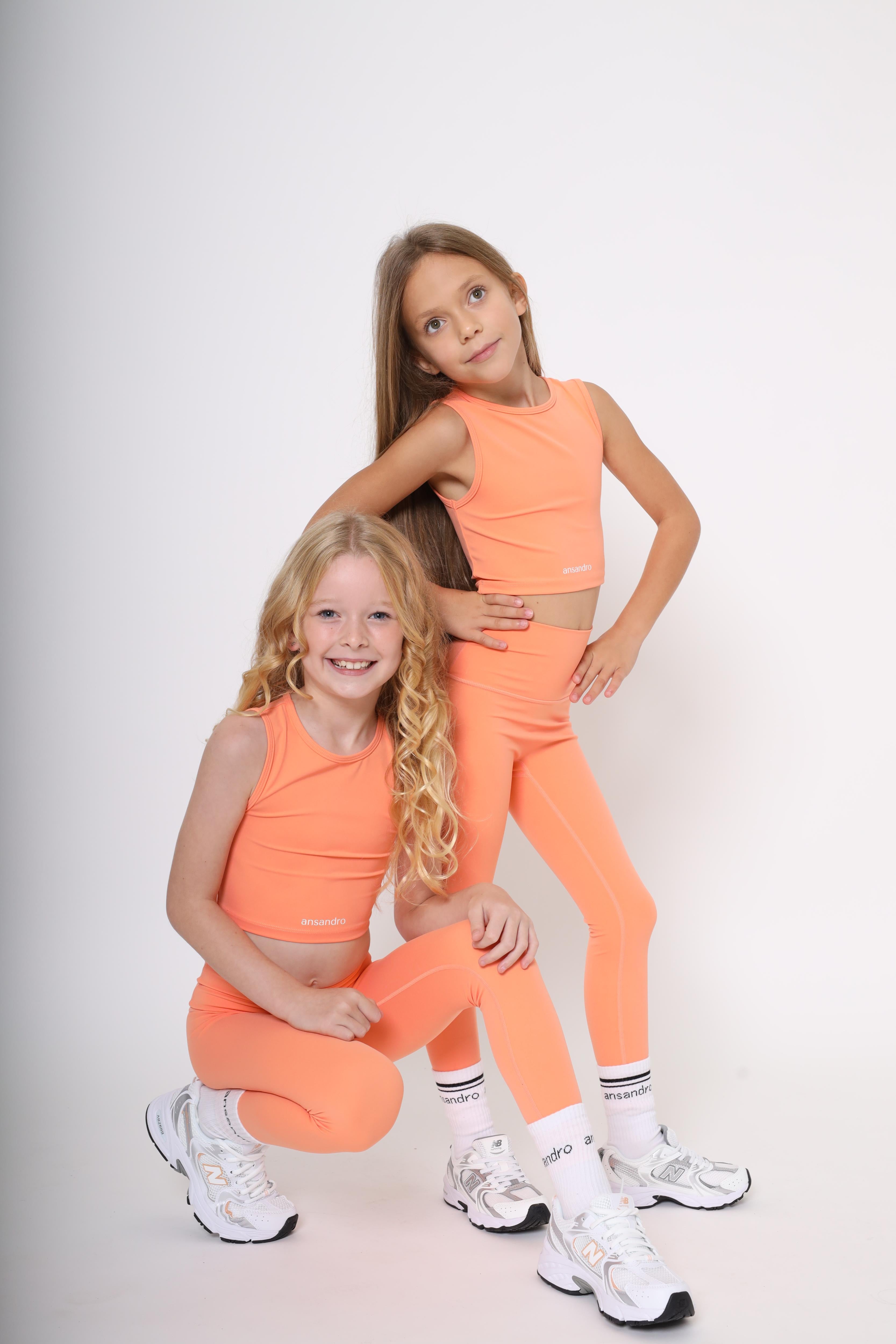 High-waisted leggings for active kids aged 5-14 - comfortable and versatile - orange with branded socks and matching cropped tank top