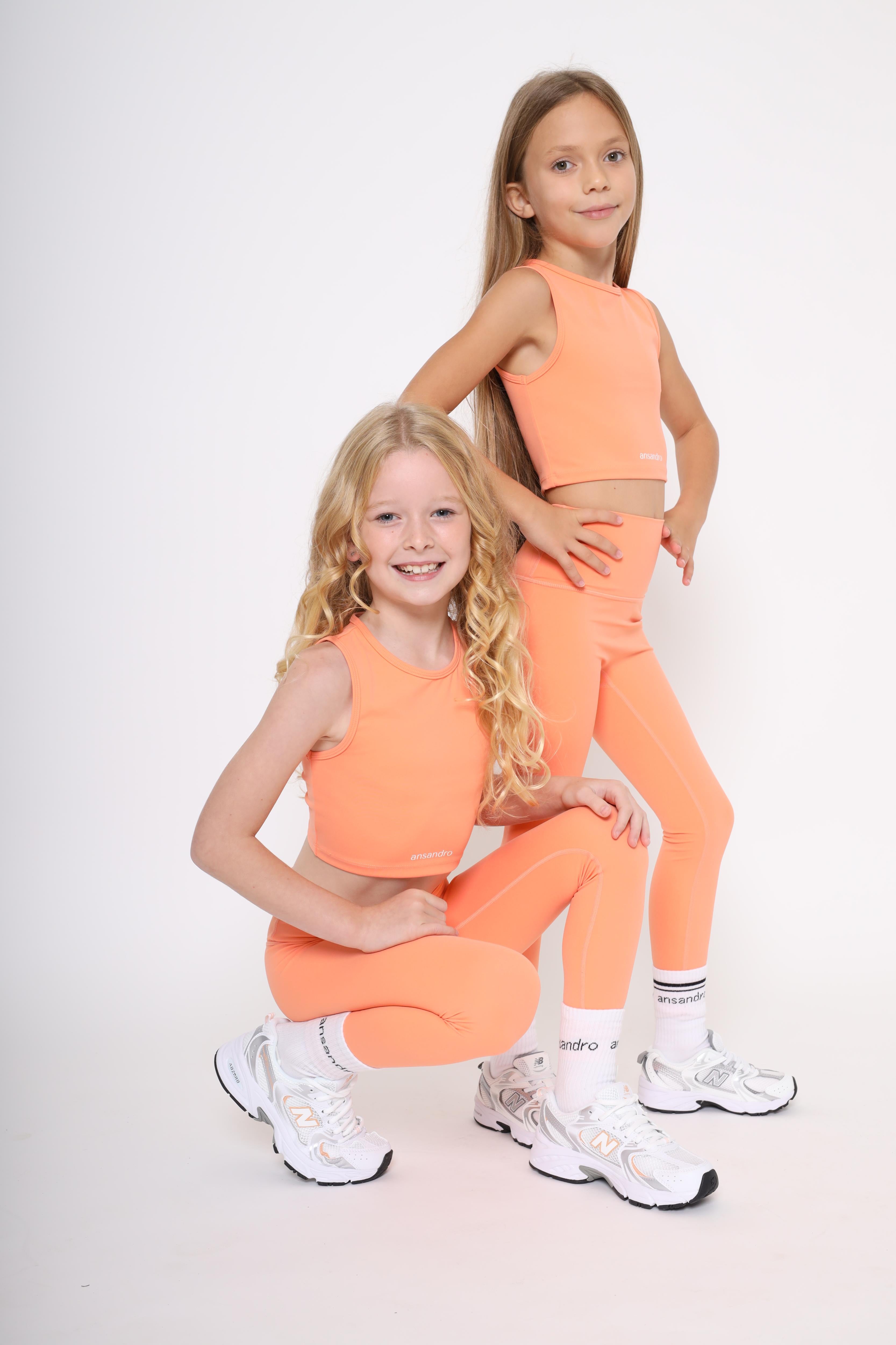 100% cotton branded socks with black text paired with girls bright high-waisted leggings and matching coral tank top