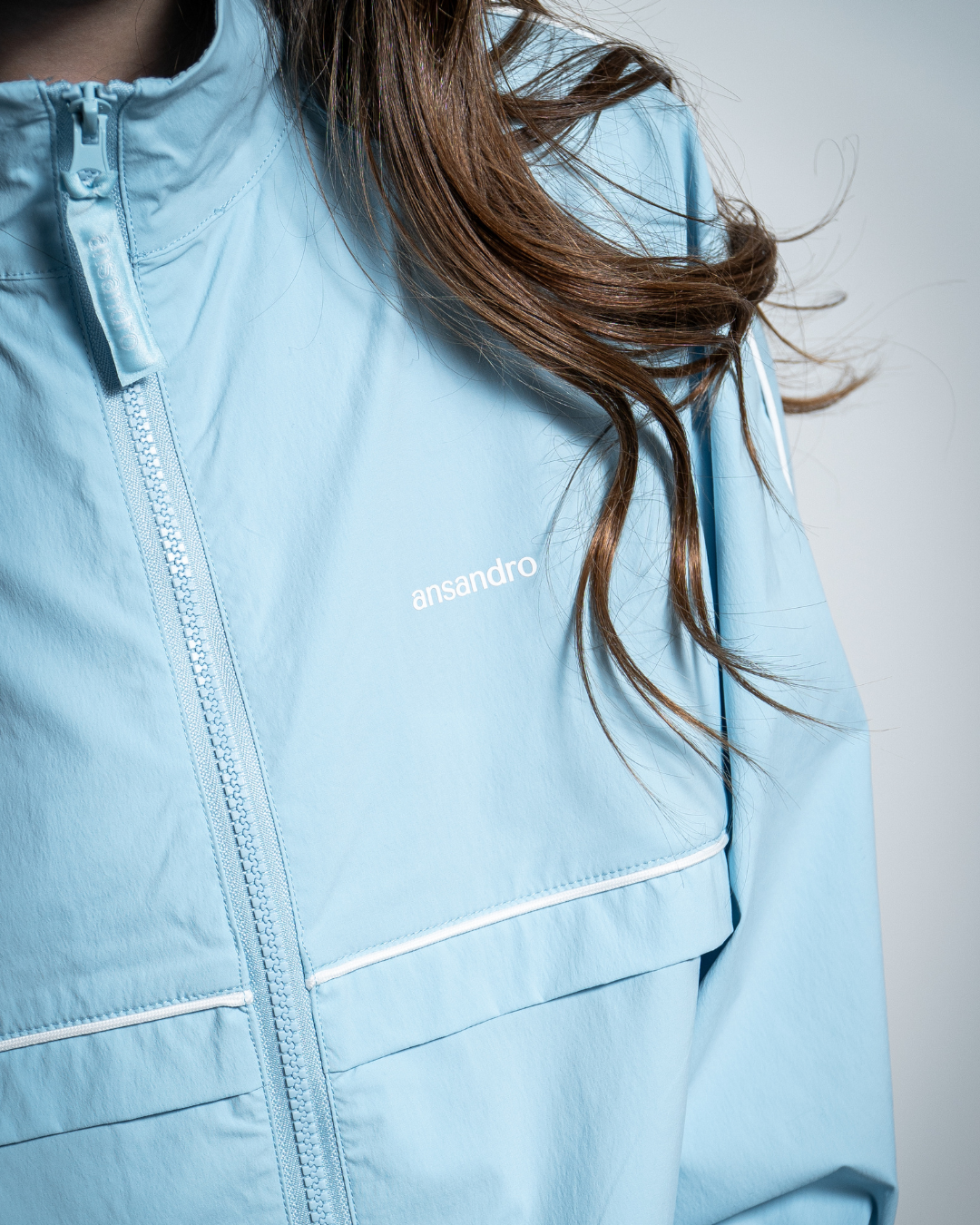 Powder blue windbreaker jacket with Ansandro branding