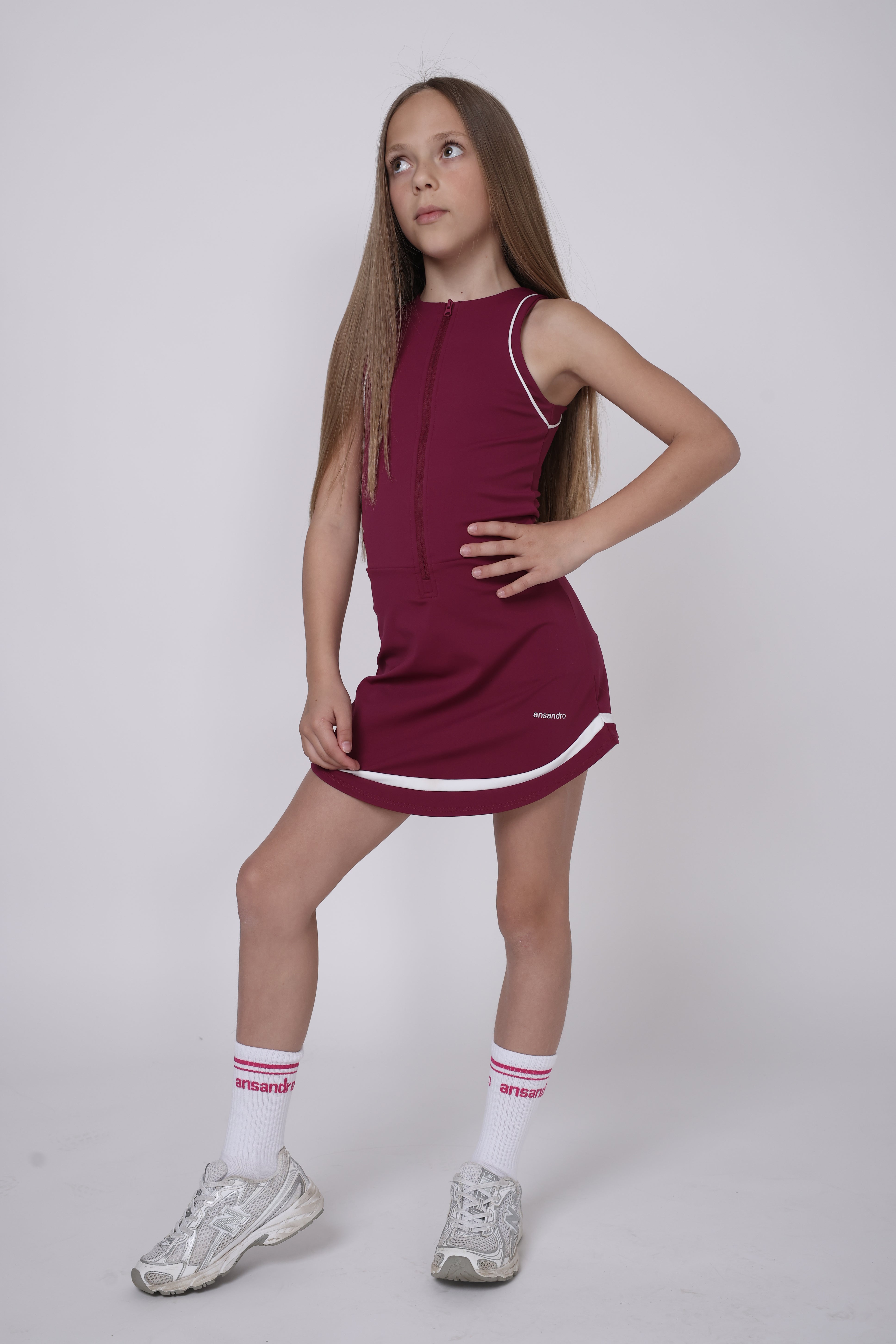 Girl wearing navy skort dress with built-in shorts by Ansandro
