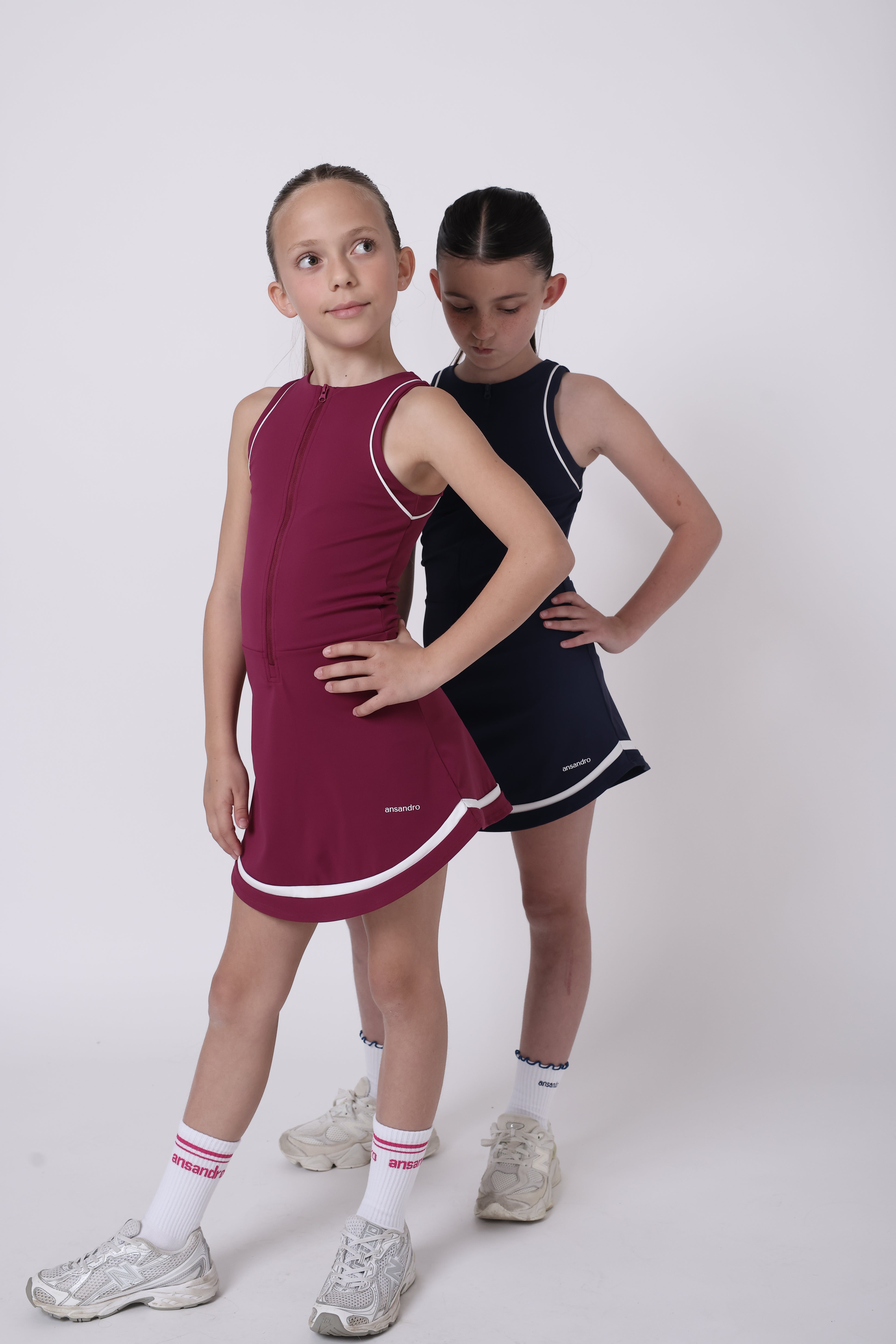 Girl wearing navy skort dress with built-in shorts by Ansandro