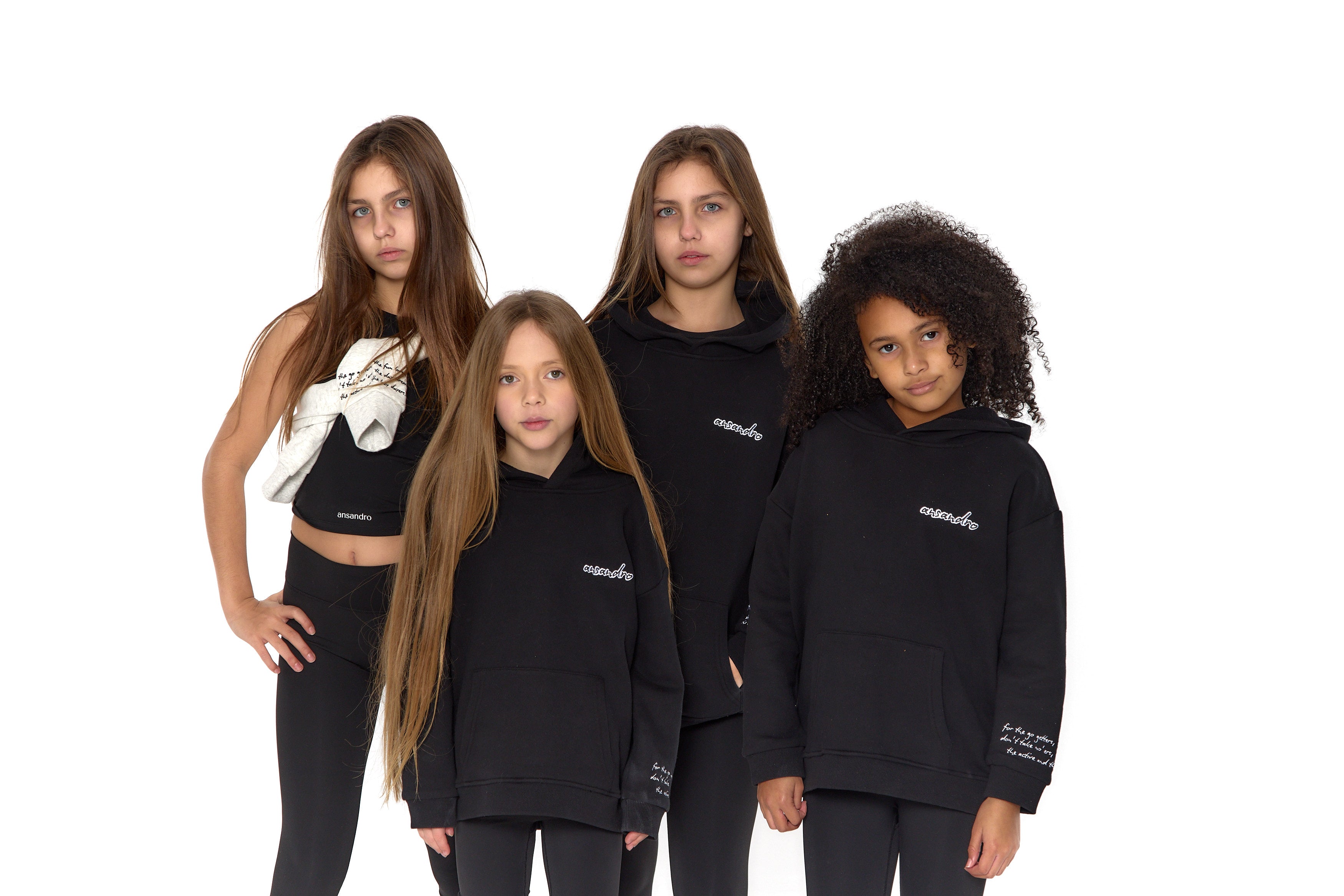 100% cotton black hoodie for kids - embroidered branding and detail - font view - girls activewear - paired with black high-waisted leggings