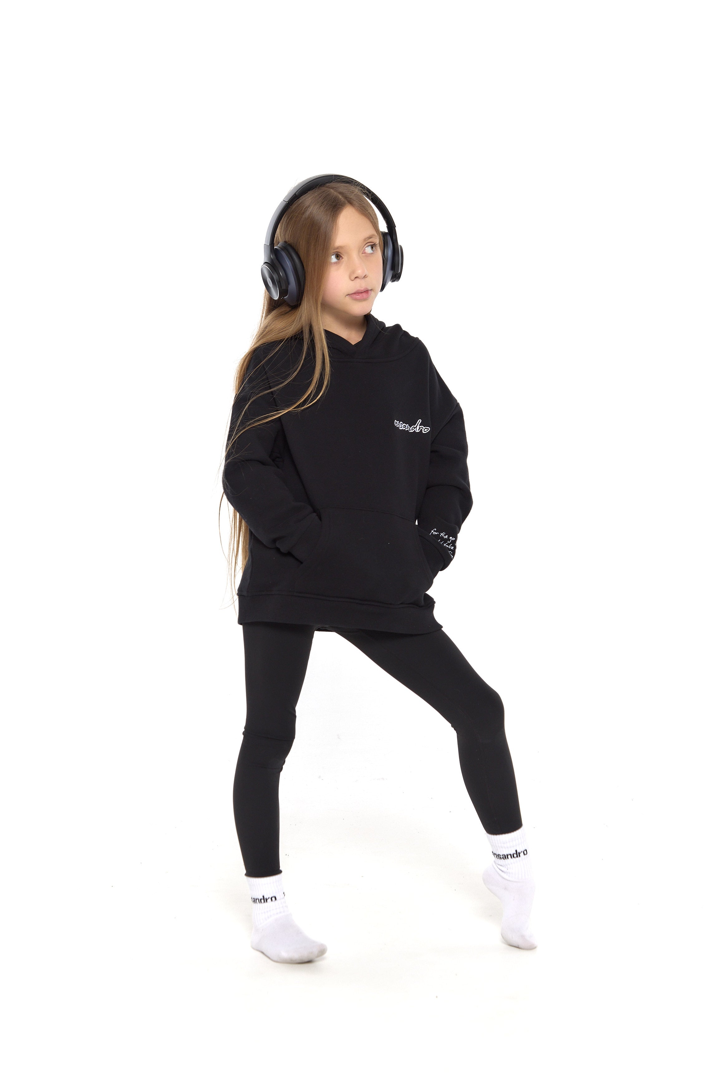 100% cotton black hoodie for kids - embroidered branding and detail - paired with black high-waisted leggings and branded socks.